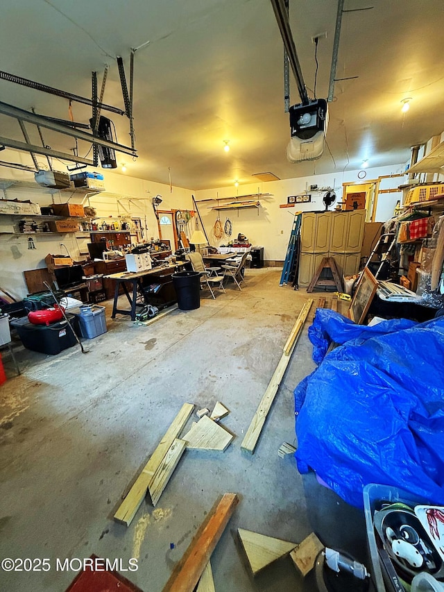 garage with a garage door opener and a workshop area