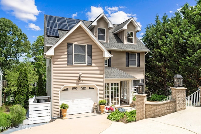 1427 Summit Ave, Toms River, NJ 08753 - view of front of house with roof with shingles, roof mounted solar panels, driveway, and a garage