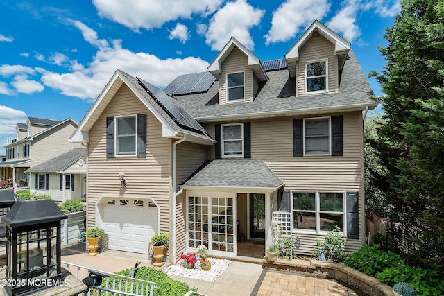 1427 Summit Ave, Toms River, NJ 08753 - view of front of house with a shingled roof, solar panels, and an attached garage