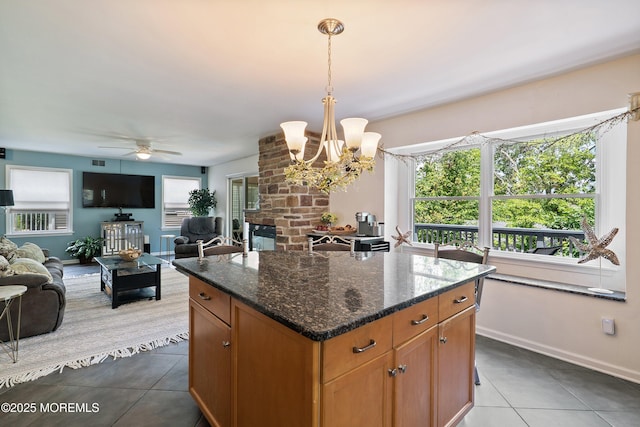 1427 Summit Ave, Toms River, NJ 08753 - kitchen with dark tile patterned floors, open floor plan, a ceiling fan, pendant lighting, and dark stone counters