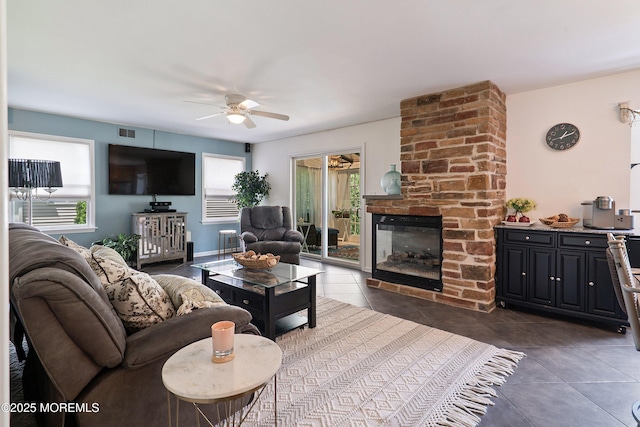 1427 Summit Ave, Toms River, NJ 08753 - living room featuring a ceiling fan, healthy amount of natural light, dark tile patterned flooring, and a multi sided fireplace