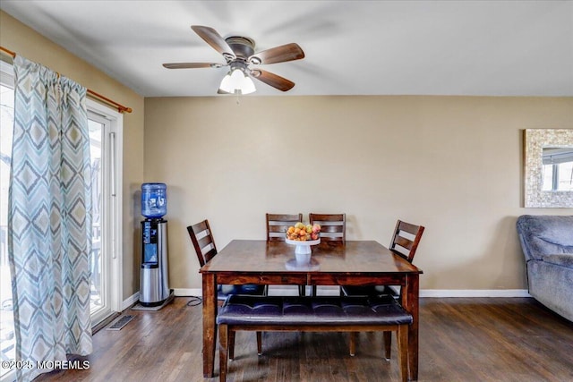 dining area featuring wood finished floors, baseboards, and ceiling fan