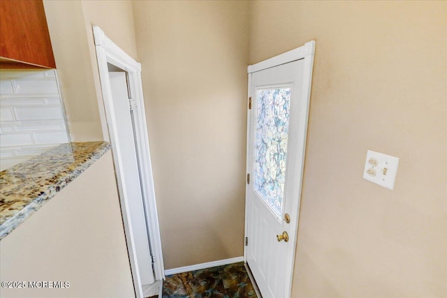 doorway with baseboards and a wealth of natural light
