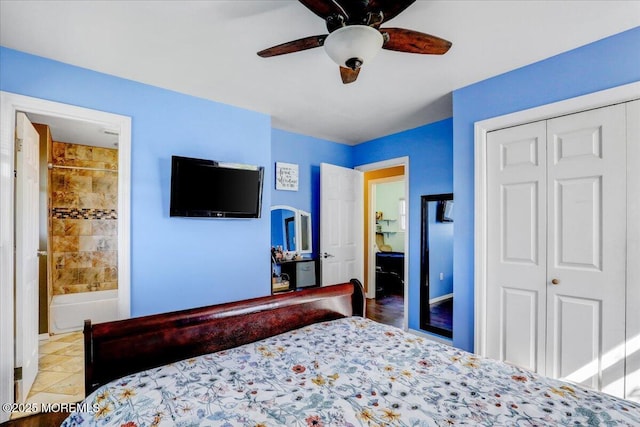 bedroom with a ceiling fan, ensuite bath, and a closet