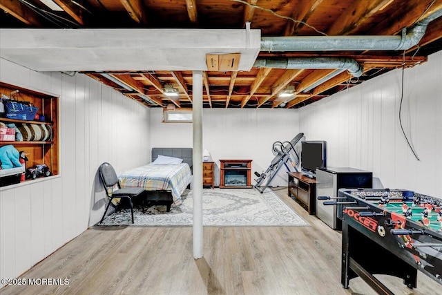 unfinished below grade area with wood finished floors and wood walls
