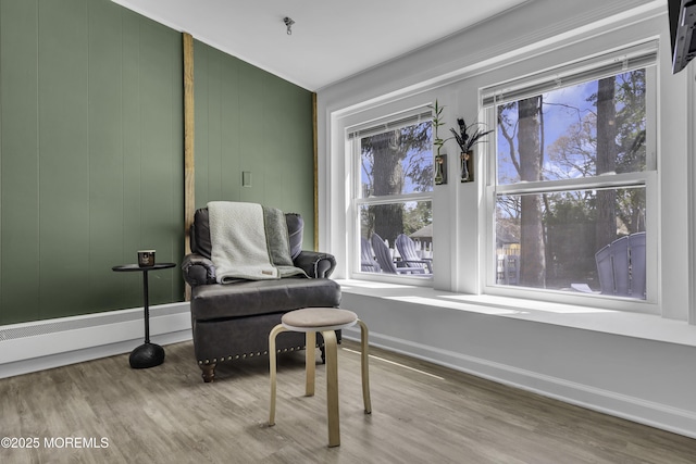 living area featuring baseboards and wood finished floors