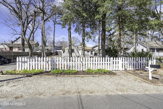 view of front of property featuring a residential view and a fenced front yard