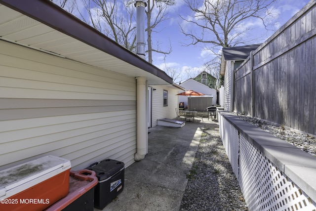 view of home's exterior with fence and a patio area