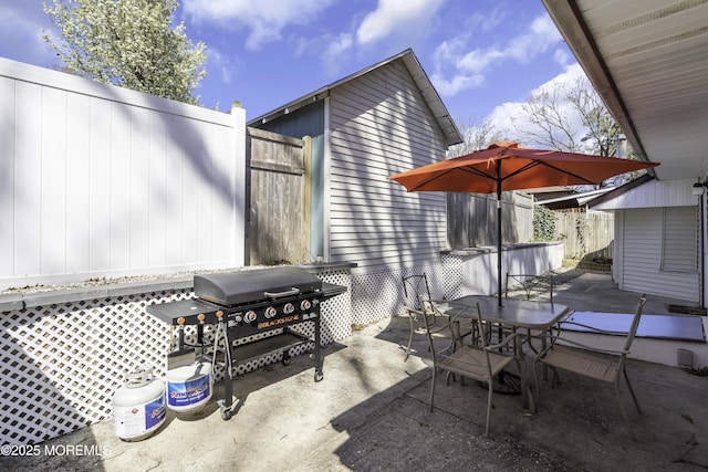 view of patio / terrace with fence, grilling area, and outdoor dining space