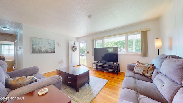 18 Forest Valley Dr, Toms River, NJ 08755 - living area with a textured ceiling, light wood-type flooring, and baseboards