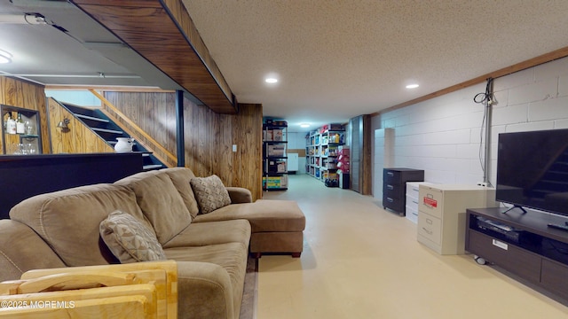 18 Forest Valley Dr, Toms River, NJ 08755 - living area featuring finished concrete flooring, concrete block wall, stairway, wood walls, and recessed lighting