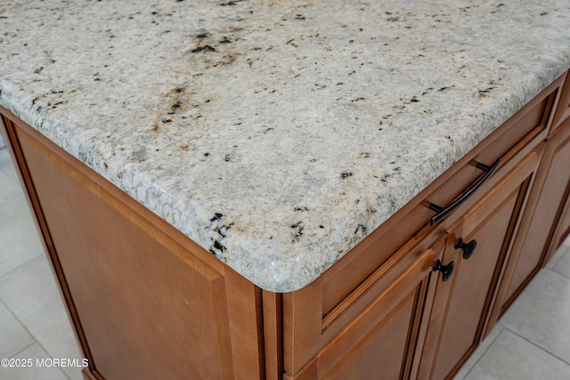 kitchen view of brown cabinetry and light stone countertops