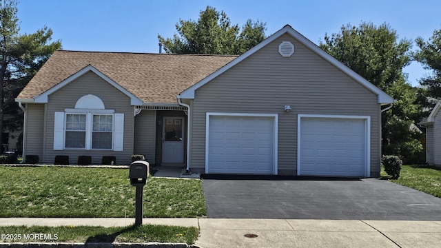 ranch-style home featuring a garage, driveway, and roof with shingles