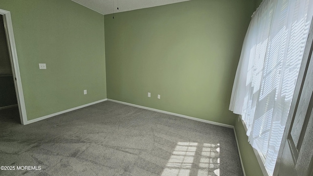 unfurnished bedroom featuring baseboards and carpet
