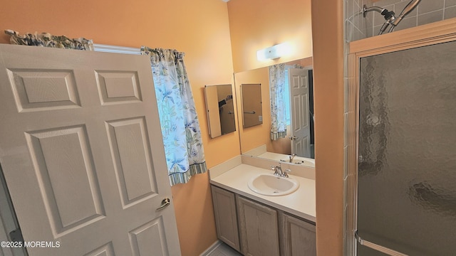 full bath featuring walk in shower and vanity