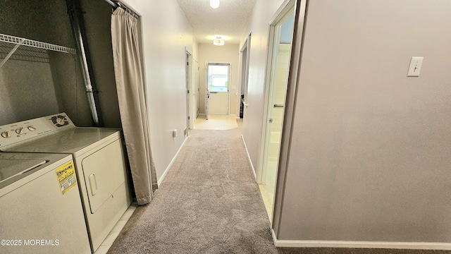 interior space featuring baseboards, light colored carpet, and separate washer and dryer