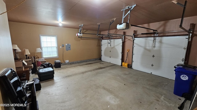 garage with a garage door opener and electric panel