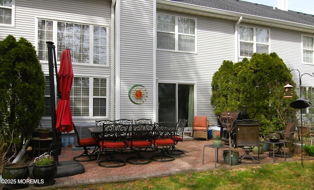 rear view of house featuring central AC, outdoor dining space, and a patio area