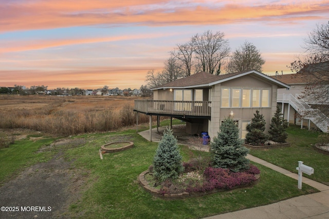 650 Front St, Union Beach, NJ 07735 - exterior space featuring a shingled roof, a wooden deck, an outdoor fire pit, and a yard