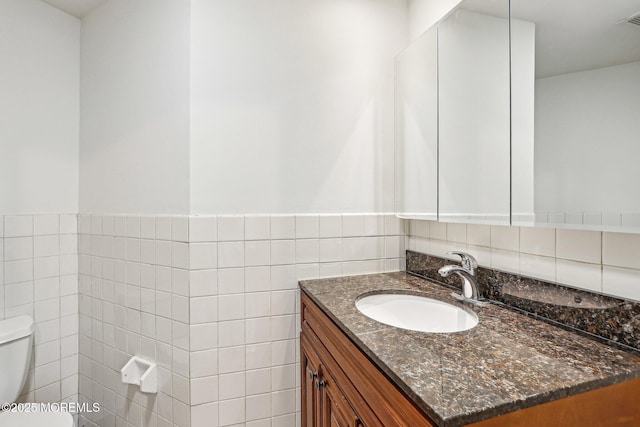 650 Front St, Union Beach, NJ 07735 - half bathroom with tile walls, visible vents, toilet, and vanity