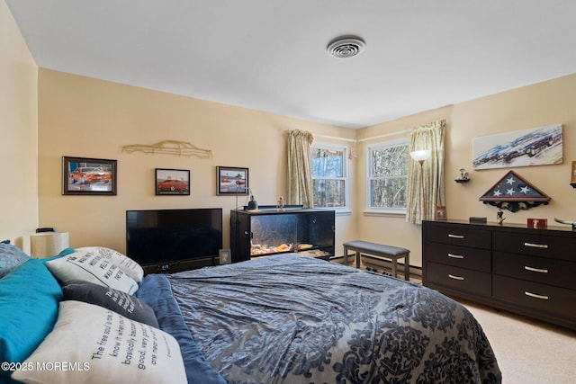 bedroom with visible vents and light colored carpet