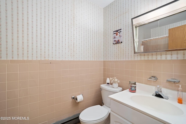 full bath with tile walls, wallpapered walls, a wainscoted wall, and toilet