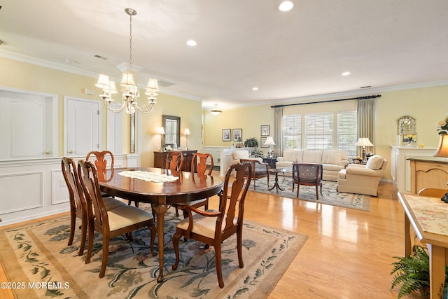 1507 Primrose Pl, Manasquan, NJ 08736 - dining room with a chandelier, light wood finished floors, crown molding, recessed lighting, and a decorative wall
