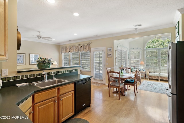 1507 Primrose Pl, Manasquan, NJ 08736 - kitchen with black dishwasher, freestanding refrigerator, dark countertops, crown molding, and light wood-type flooring