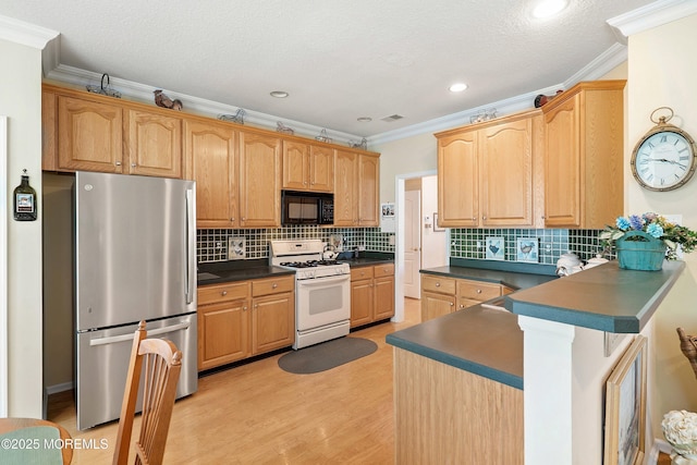 1507 Primrose Pl, Manasquan, NJ 08736 - kitchen featuring freestanding refrigerator, gas range gas stove, black microwave, dark countertops, and ornamental molding