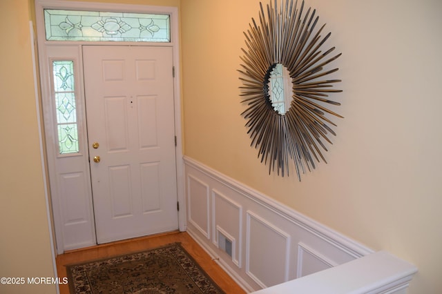 1507 Primrose Pl, Manasquan, NJ 08736 - entryway with wainscoting, a decorative wall, and light wood-style floors