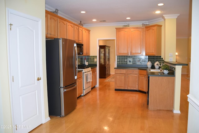 1507 Primrose Pl, Manasquan, NJ 08736 - kitchen featuring freestanding refrigerator, gas range gas stove, dark countertops, ornamental molding, and decorative backsplash