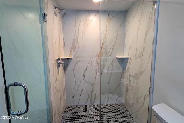 full bath featuring a marble finish shower and toilet