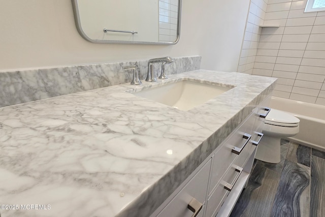 bathroom featuring toilet and vanity
