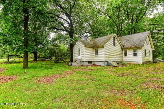 94 Topanemus Ln, Freehold, NJ 07728 - view of side of property with a yard, roof with shingles, and view of scattered trees