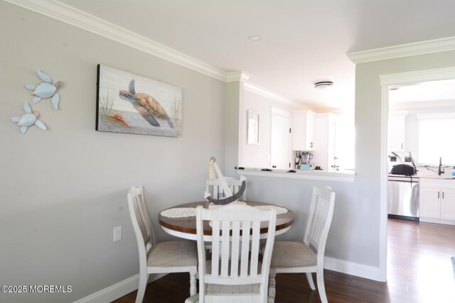 dining area with baseboards, dark wood-style flooring, and crown molding