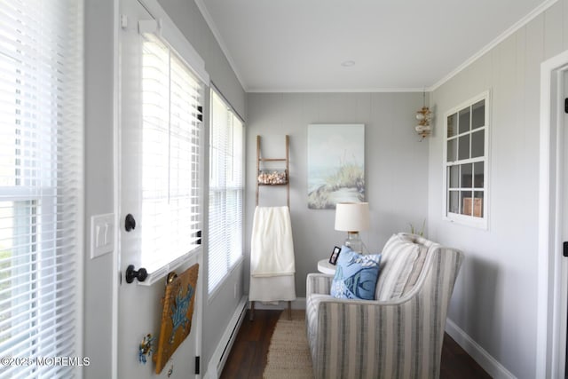 sitting room featuring a baseboard radiator, baseboards, crown molding, and wood finished floors