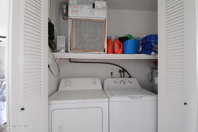 washroom with independent washer and dryer and laundry area