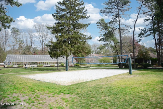surrounding community featuring volleyball court and a yard