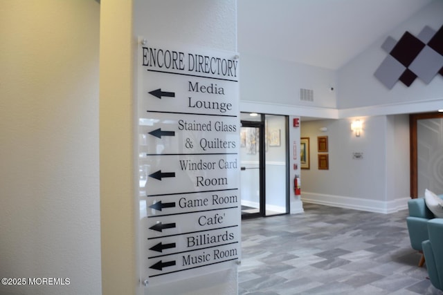 interior space with visible vents, a fire extinguisher, tile patterned floors, and baseboards