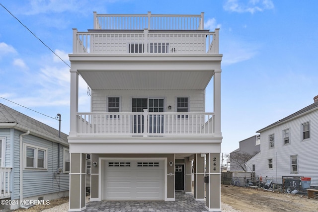 322 Lincoln Ave, Seaside Heights, NJ 08751 - view of front of property featuring fence, decorative driveway, a balcony, and a garage