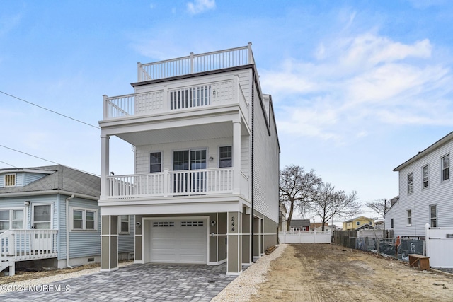 322 Lincoln Ave, Seaside Heights, NJ 08751 - view of front of property featuring an attached garage, driveway, a balcony, and fence