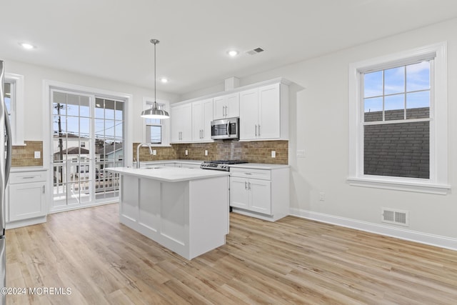 322 Lincoln Ave, Seaside Heights, NJ 08751 - kitchen with a sink, visible vents, light wood-style floors, backsplash, and appliances with stainless steel finishes