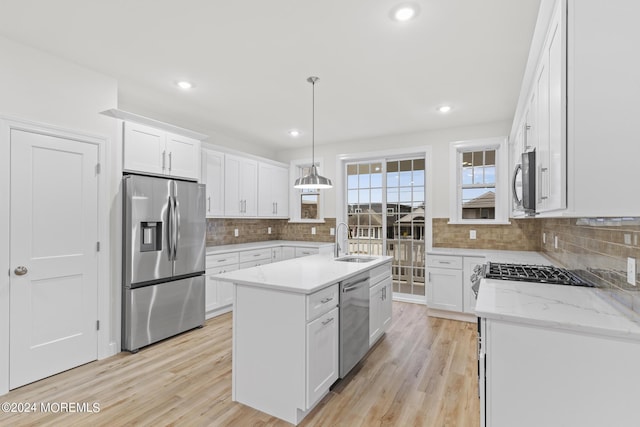 322 Lincoln Ave, Seaside Heights, NJ 08751 - kitchen with a sink, decorative backsplash, stainless steel appliances, a center island with sink, and white cabinetry