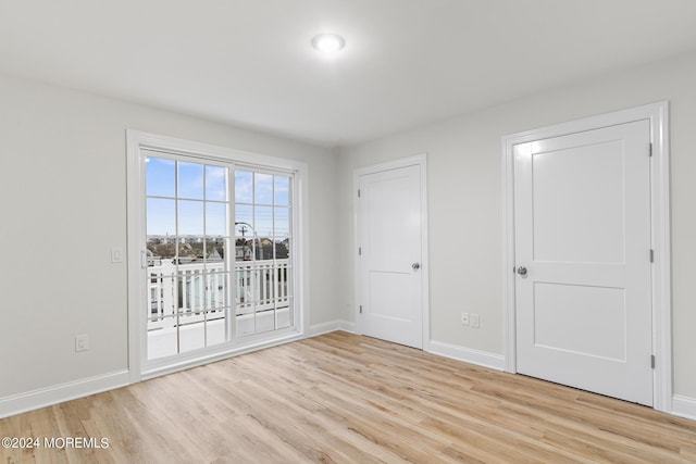 322 Lincoln Ave, Seaside Heights, NJ 08751 - unfurnished bedroom featuring light wood-style floors, access to exterior, and baseboards