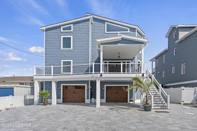 107 Bay Shore Dr, Toms River, NJ 08753 - view of front of property featuring fence, stairs, an attached garage, decorative driveway, and a balcony