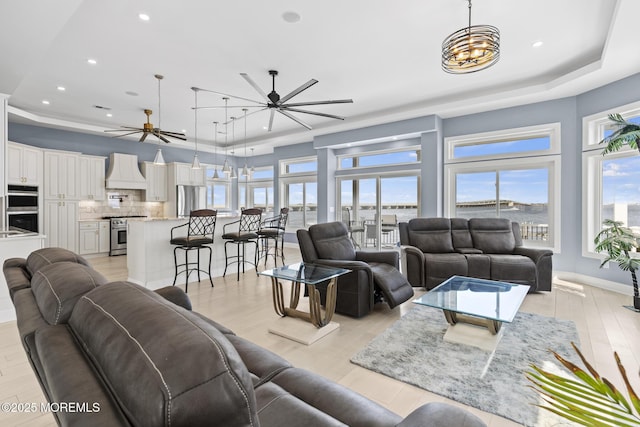 107 Bay Shore Dr, Toms River, NJ 08753 - living area featuring ceiling fan with notable chandelier, a tray ceiling, recessed lighting, and light wood-style flooring