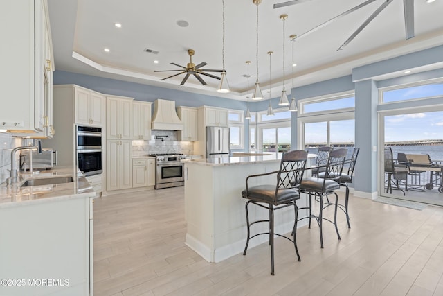 107 Bay Shore Dr, Toms River, NJ 08753 - kitchen featuring decorative backsplash, custom exhaust hood, light wood-style floors, a sink, and stainless steel appliances