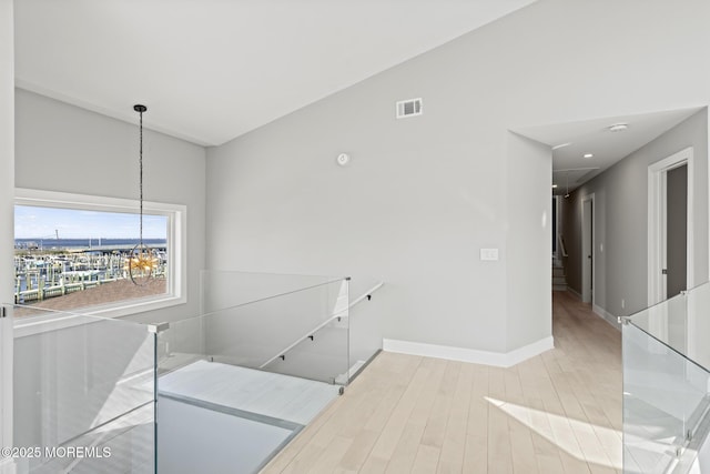 107 Bay Shore Dr, Toms River, NJ 08753 - hall with a notable chandelier, baseboards, an upstairs landing, wood finished floors, and visible vents