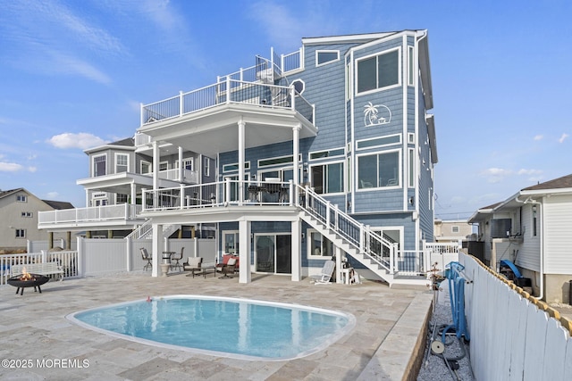107 Bay Shore Dr, Toms River, NJ 08753 - rear view of property featuring stairway, a fenced in pool, a fenced backyard, a patio, and a fire pit
