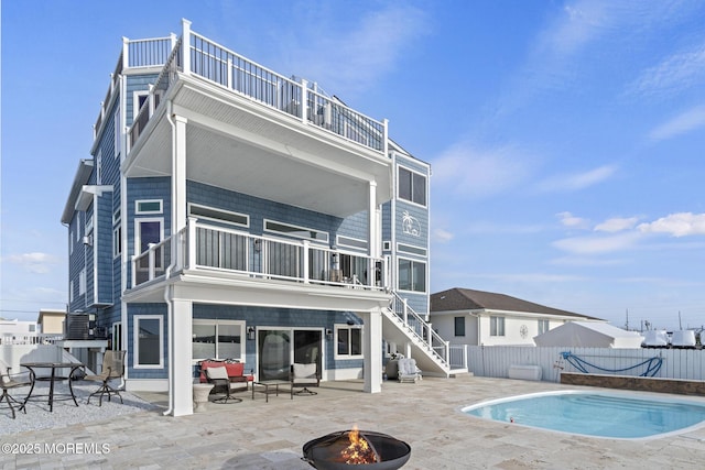 107 Bay Shore Dr, Toms River, NJ 08753 - back of property featuring a fire pit, fence, a balcony, a patio, and stairway
